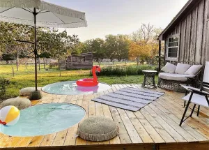 Image of Texas Cabin with cowboy pool and fire pit. Located in Bryan TX.