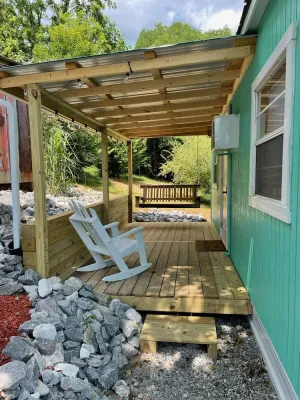Image of Tiny house with deck and swing