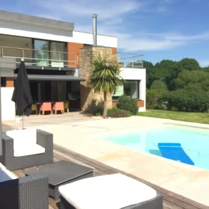 Image of Contemporary house with swimming pool, jacuzzi and gym.