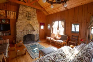 Image of Classic cabin\/cottage with big screen porch, stone fireplace, knotty pine walls.