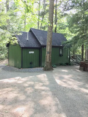 Image of Cabin in woods, with row to the lake