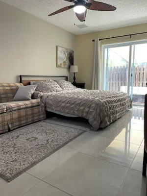 Image of Cozy room with pool and patio.