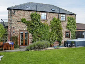 Image of A red brick barn conversion situated on an arable farm with views of open countryside.