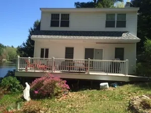 Image of House on The Lake Is a peaceful getaway with beautful grounds with stonewalls