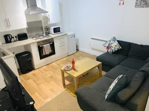 Image of Enjoy a spacious lounge with a cozy sofa bed and a private ensuite bedroom