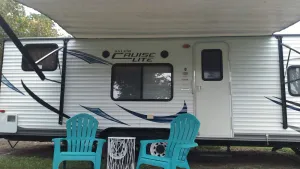 Image of Camper near pool at Pebble Hill RV Resort