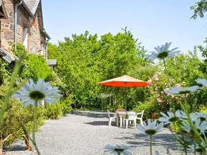 Image of Norman house surrounded by nature