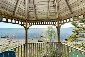 Image of Charming home with stunning bay views, sunroom, gazebo, deck, & grill