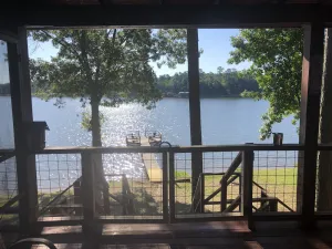 Image of Lakefront rustic log cabin. Any season vacation, get away, or retreat.