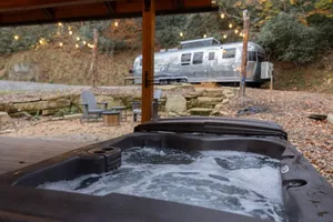 Image of Airstream w\/ Bathtub, River, & Hot Tub