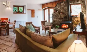 Image of A rustic, stonewalled property with open living room & cosy log fire