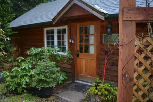 Image of This romantic cabin at Mt. Rainier is a one room cabin with private hot tub right on Copper Creek. It has a queen bed and a queen Murphy bed. Walk to Copper Creek Restaurant. Beautiful woodland setting.