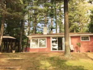 Image of Relaxing Waterfront Cabin Located On A Sandy Bottom Crystal Clear Lake.