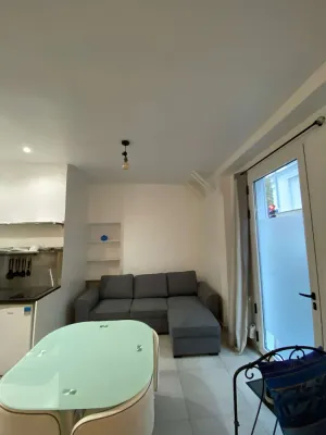 Image of The apartment has a bed, a sofa bed and a kitchen with a refrigerator.