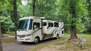 Image of Class A RV on a private 5 Acre Property with RV campsite and trail.