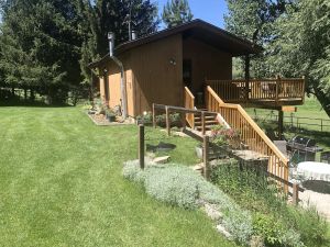 Image of A wonderful, secluded 2 story cabin, deck, fire pit, stocked pond for fishing.