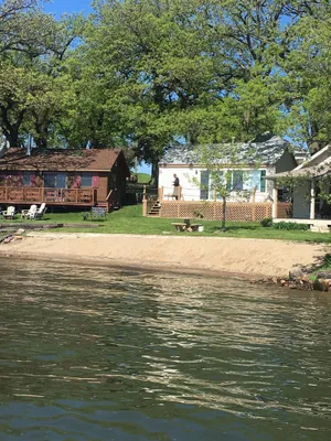 Image of Prime East Lake beachfront cabin with boat hoist in Okoboji