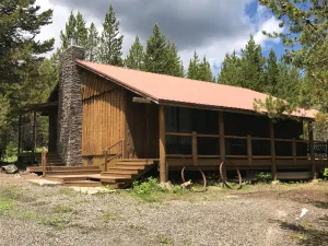Image of Porch lined cabin nestled in the Pines for lazy summer days