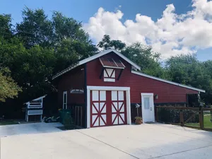 Image of The little red barn in the city