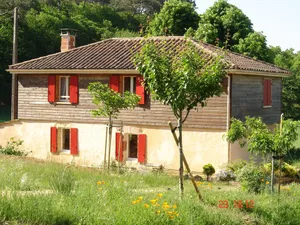 Image of House in the countryside, with large expanses of woods and fields.