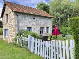 Image of House made of regional stones, typical from Auvergne, greenery landscape