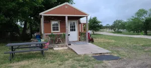 Image of Cozy Tiny Cabin with a small porch and firepit.