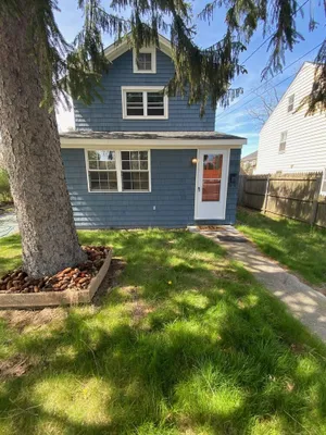 Image of Charming Riverhead home with large outdoor patio & backyard  firepit