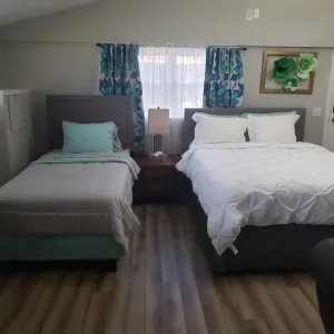Image of Renovated Suite with 1 queen bed and a Twin. Kitchen & bath for your privacy.