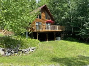 Image of Light-Filled Log Home, 4 Wooded Acres, & Lake Access.  The water is 0.4 mi away.