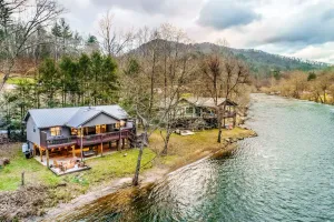 Image of Riverfront getaway with a deck, yard, private hot tub, fireplace, and grill