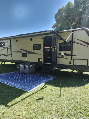 Image of Beautiful travel trailer with private fenced in yard, deck, and fire pit.