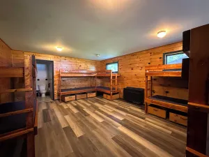 Image of A summer camp cabin with attached bath and lounge area