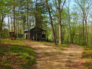 Image of Line Camp Cabin is Secluded in The Woods Near The River.
