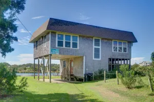 Image of Cove-front home with rooftop deck, boat dock, water views, & A\/C