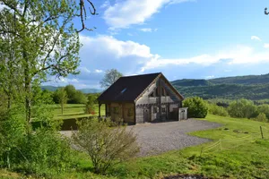 Image of Secluded chalet in the sun with breathtaking views of a wooded valley