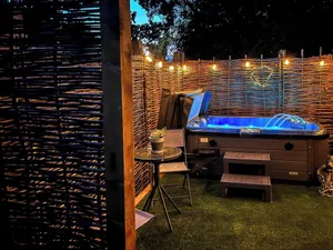 Image of Romantic and luxurious stay with your own private hot tub to enjoy, and luxurious vaulted ceilings.