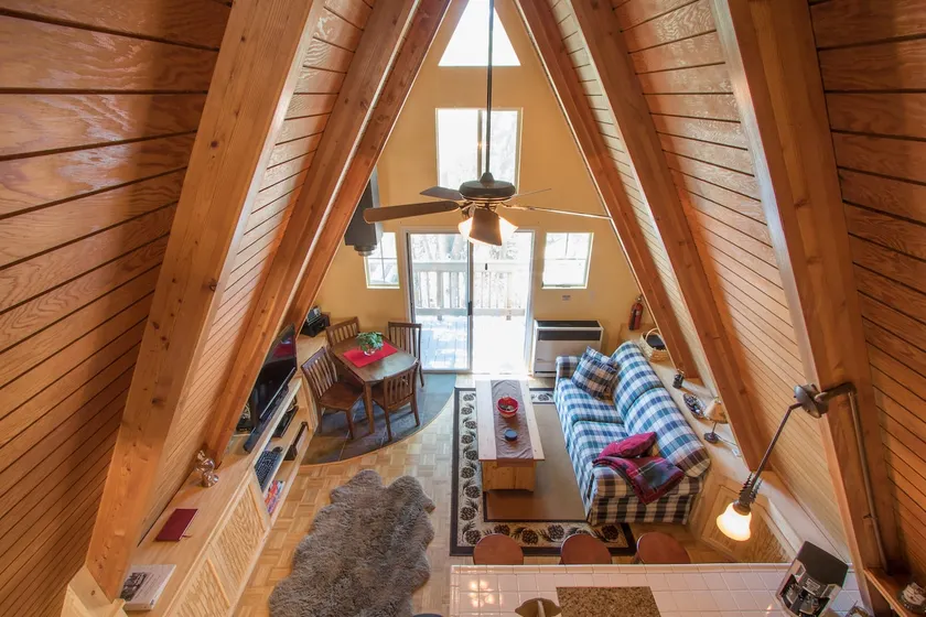 Small A-frame cabin on dirt road - Image 1