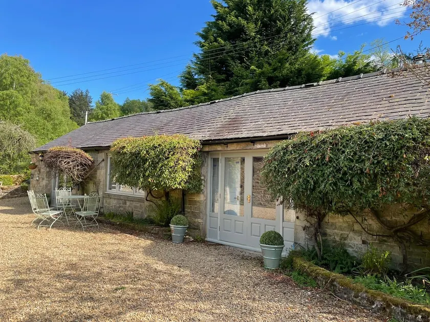 Magical cottage surrounded by trees and water - Image 1