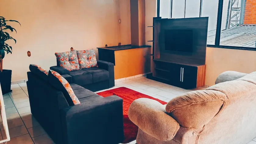 Spacious house with a wood-burning stove/fireplace in the living room. - Image 1