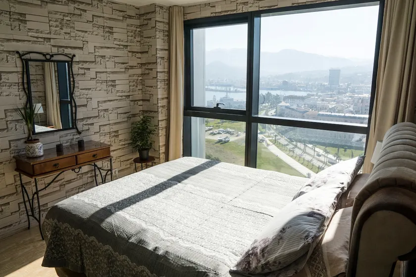 Beachfront with sea, city and mountain views - Image 1