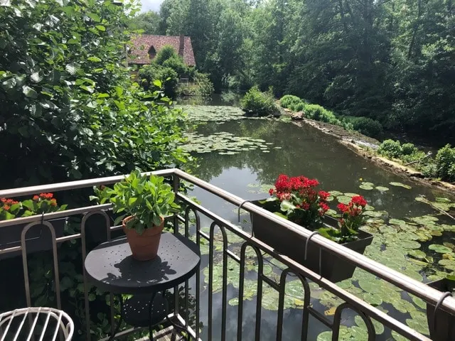 Secluded cottage on a river below a medieval town - Image 1