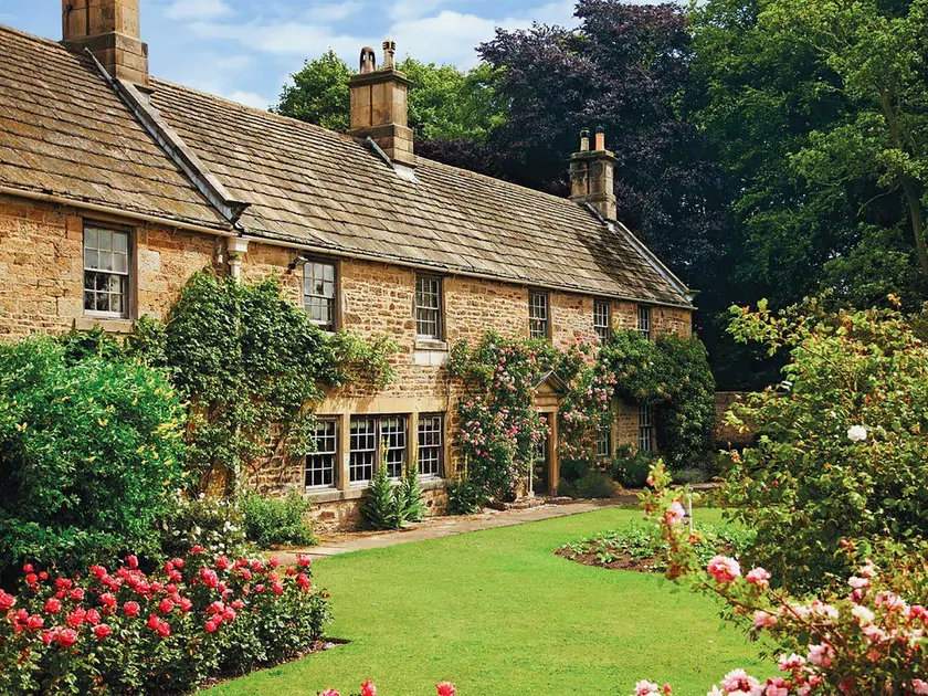 Historic manor house surrounded by mature gardens - Image 1