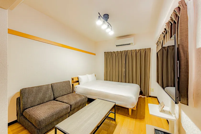 5-minute walk from Fukuoka Tenjin subway station. Renovated apartment. 1 double bed and 1 sofa bed. - Image 1