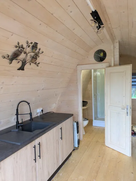 A small, comfortable cabin in a village. - Image 1