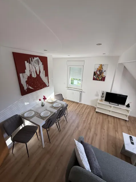 Stylish attic apartment with box spring bed - Image 1