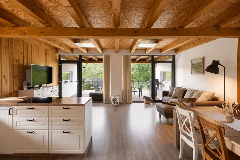 Modern cottage with large covered terrace by pond - Image 1