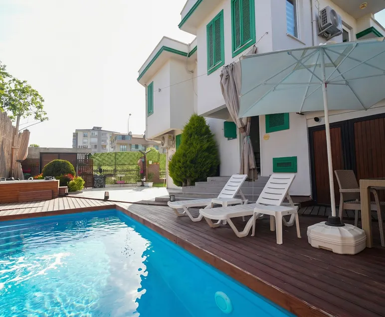 Villa with Green Shutters and Garden - Image 1