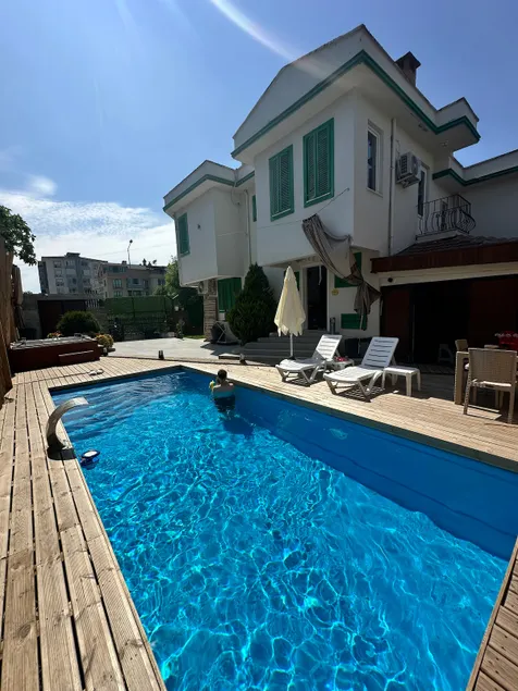Villa with Green Shutters and Garden - Image 1
