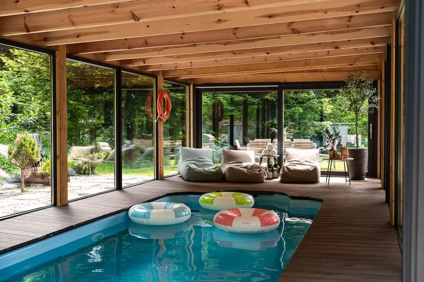 A year-round, covered, heated swimming pool and a hot tub. - Image 1