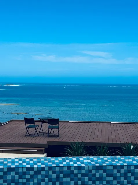 Experience the ultimate relaxation in a semi-open-air bath while taking in the stunning ocean view. - Image 1